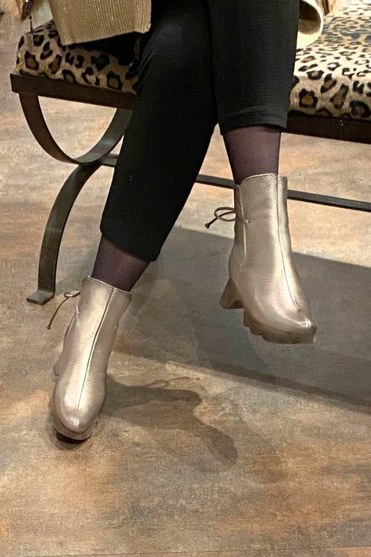Gold women's ankle boots with laces at the back. Round toe. Low rubber soles. Worn view - Florence KOOIJMAN